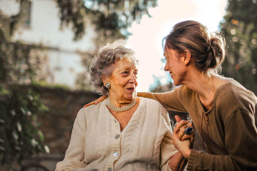 An older woman and a younger woman talk