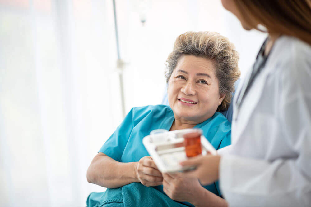 A woman receives medication assistance 