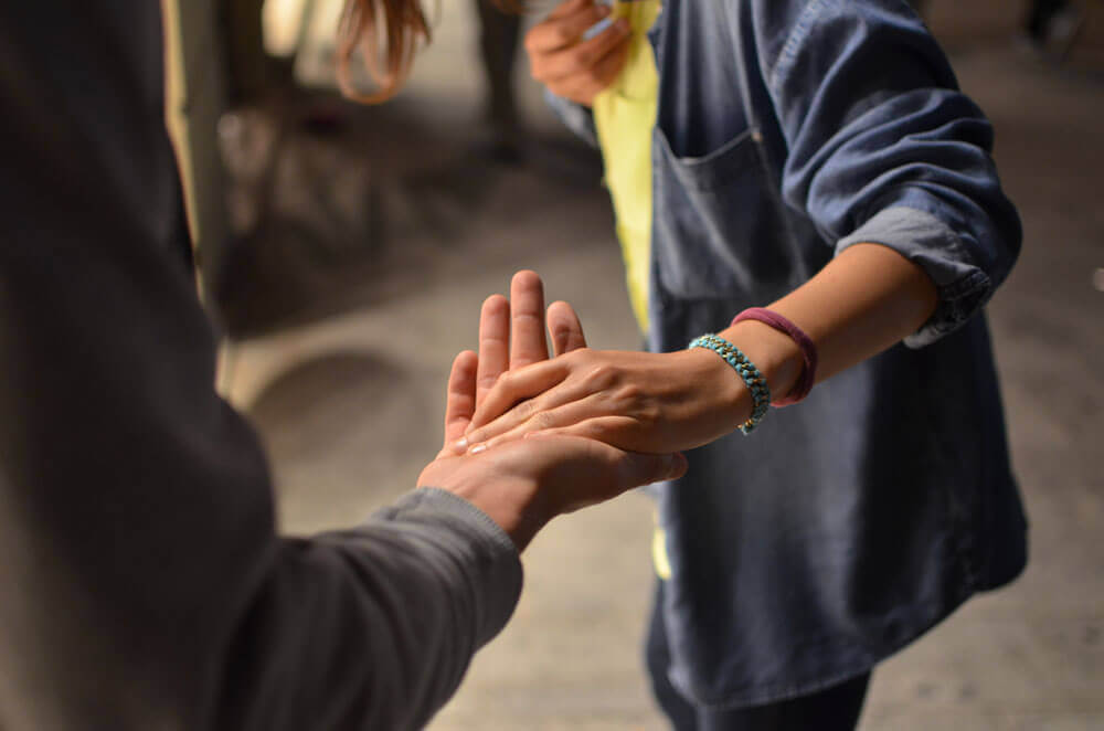 Two people holding hands showing NDIS mentoring services
