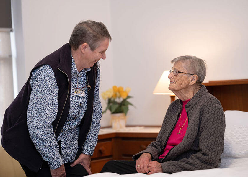 An elderly person talks to a Carers and Disability Link team member