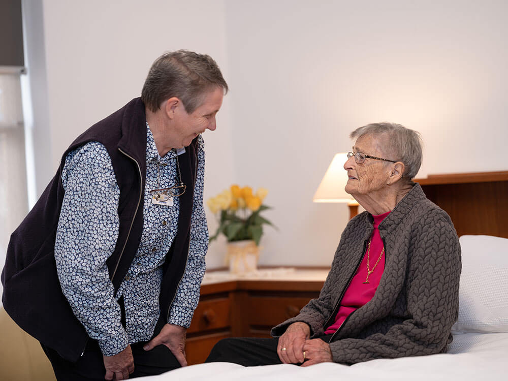 An elderly person talks to a Carers and Disability Link team member