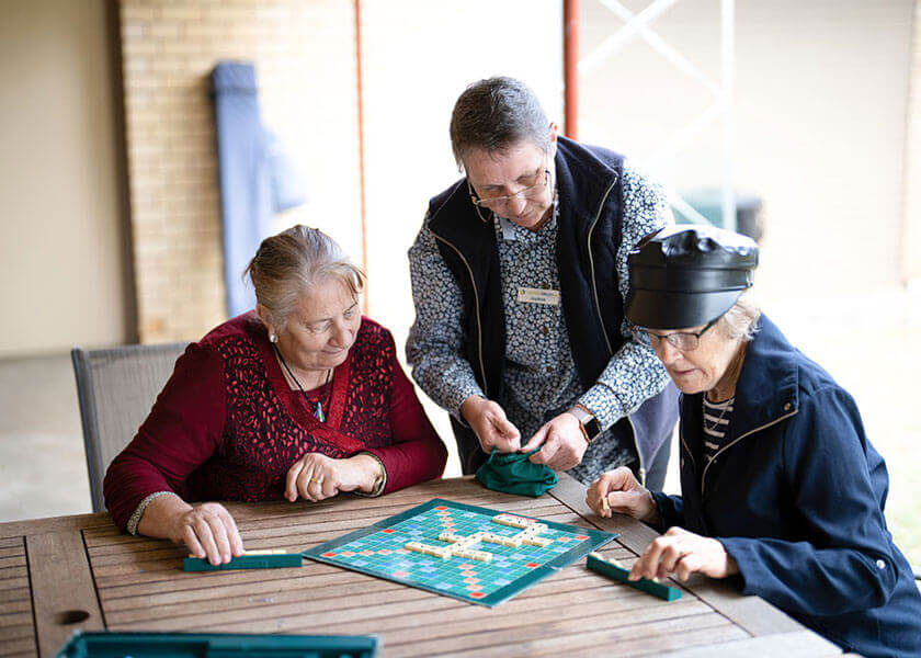 Three women playing a board game