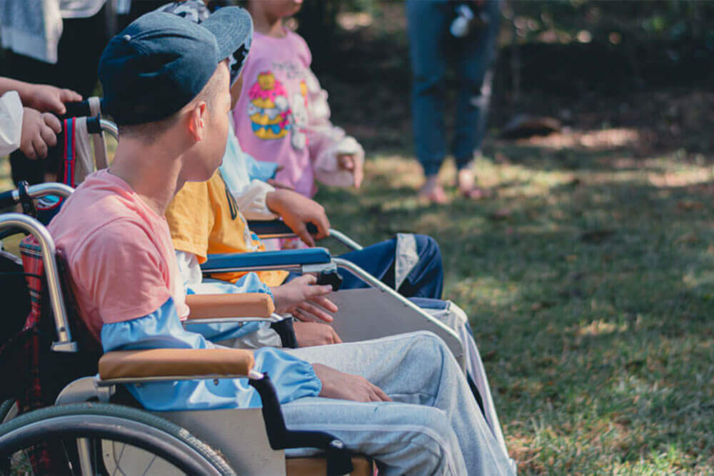 children in wheelchairs listening
