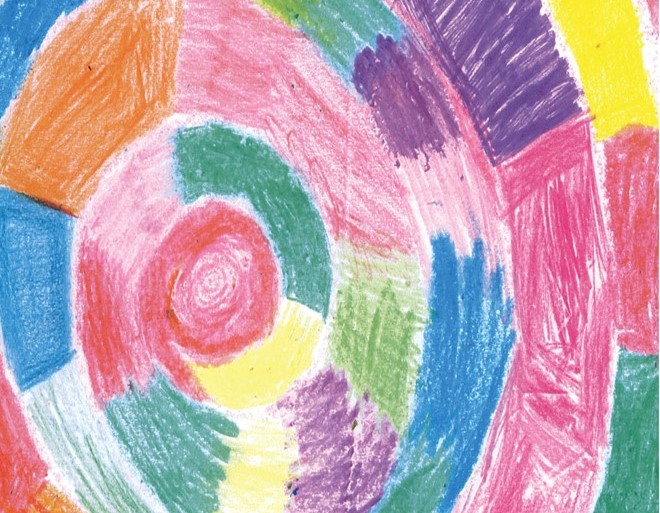 a young woman smiles at an older woman in a wheelchair